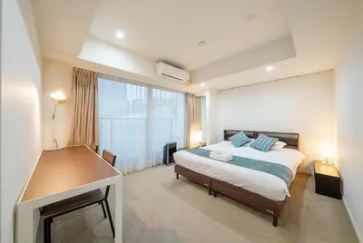 a bedroom with a bed and a large window at angoo Shinagawa Room 603 - Vacation STAY 00071v in Tokyo