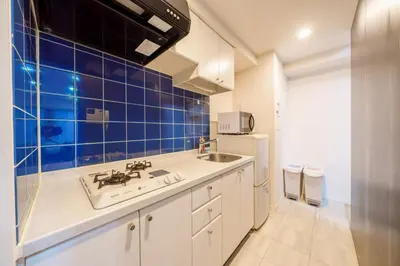 a kitchen with a sink and a blue tiled wall at angoo Shinagawa Room 603 - Vacation STAY 00071v in Tokyo