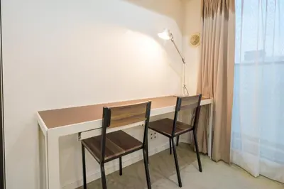 a desk with two chairs and a lamp at angoo Shinagawa Room 603 - Vacation STAY 00071v in Tokyo