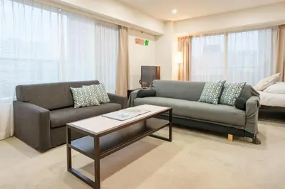 a living room with two couches and a coffee table at angoo Shinagawa Room 603 - Vacation STAY 00071v in Tokyo