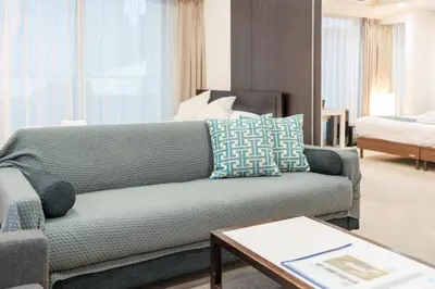 a living room with a couch and a bed at angoo Shinagawa Room 603 - Vacation STAY 00071v in Tokyo