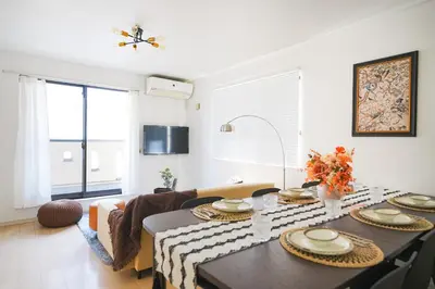 a living room with a table and a couch at Panda Style 3-story 9ppl House FreeParking 3br&tub in Tokyo
