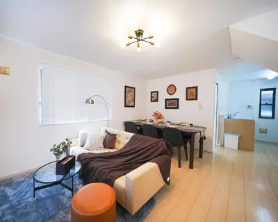 a bedroom with a bed and a dining room at Panda Style 3-story 9ppl House FreeParking 3br&tub in Tokyo