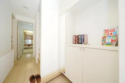 a hallway with white cabinets and a pair of shoes at Panda Style 3-story 9ppl House FreeParking 3br&tub in Tokyo