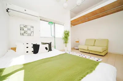 a bedroom with a bed and a yellow couch at Panda Style 3-story 9ppl House FreeParking 3br&tub in Tokyo