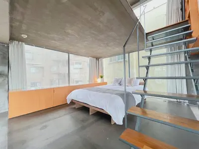 a bedroom with a bed and a staircase at Natsumezaka Room3 NM3 in Tokyo