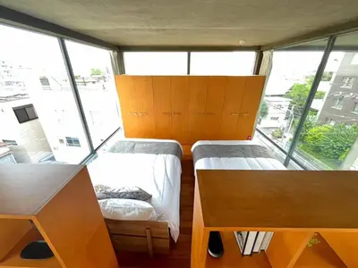 two beds in a room with large windows at Natsumezaka Room3 NM3 in Tokyo