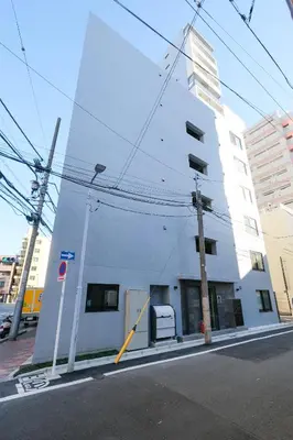 a white building on the side of a street at Mi-HOTEL ASAKUSA in Tokyo
