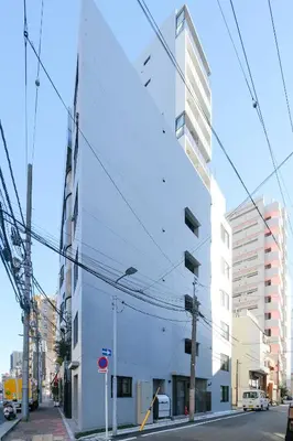 a white building on the side of a street at Mi-HOTEL ASAKUSA in Tokyo