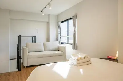 a living room with a couch and a chair at Mi-HOTEL ASAKUSA in Tokyo
