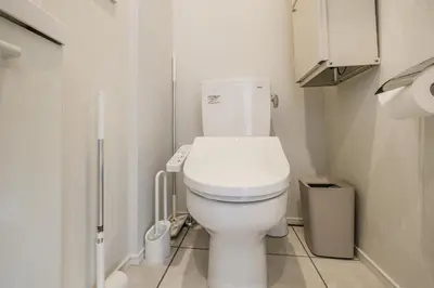 a bathroom with a white toilet in a small room at Mi-HOTEL ASAKUSA in Tokyo