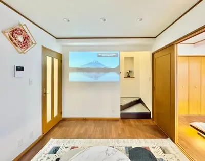 a living room with a large painting on the wall at sun inn in Tokyo
