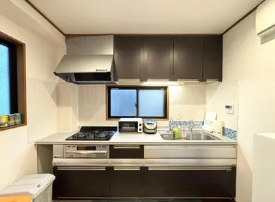 a kitchen with a sink and a stove top oven at sun inn in Tokyo