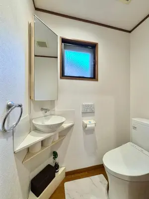 a white bathroom with a sink and a toilet at sun inn in Tokyo