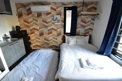 a room with two beds in a tiny house at Senzoku 1 Chome in Tokyo