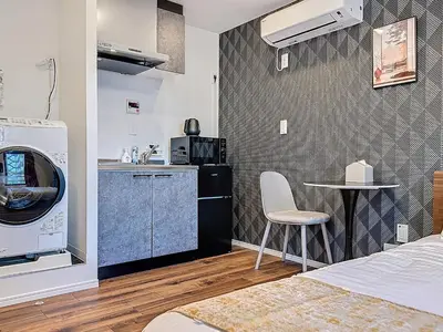 a kitchen with a washing machine and a table at Senzoku 1 Chome in Tokyo