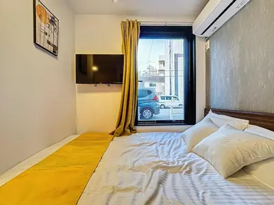 a bedroom with a large bed with a window at Senzoku 1 Chome in Tokyo