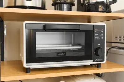 a microwave oven sitting on a shelf in a kitchen at Paradiso\u9752\u6238 in Tokyo