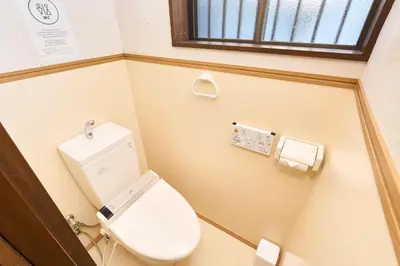 a small bathroom with a toilet and a window at Paradiso\u9752\u6238 in Tokyo