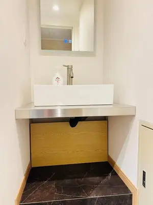 a bathroom with a white sink and a mirror at World House Kameido -Direct to Akihabara&Shinjuku, near Asakusa &Skytree, 30 mins to Disney by train in Tokyo