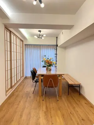 a dining room with a table with flowers on it at World House Kameido -Direct to Akihabara&Shinjuku, near Asakusa &Skytree, 30 mins to Disney by train in Tokyo