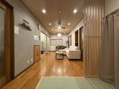 a hallway with a living room with a couch at nestay villa tokyo ueno in Tokyo