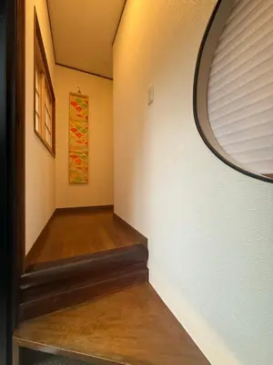 a hallway with a circular mirror on the wall at nestay villa tokyo ueno in Tokyo
