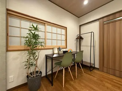 a room with a table and chairs and a plant at nestay villa tokyo ueno in Tokyo