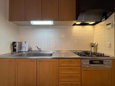 a kitchen with a sink and a stove at nestay villa tokyo ueno in Tokyo