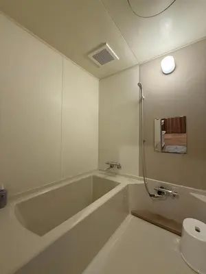 a bathroom with a bath tub and a sink at nestay villa tokyo ueno in Tokyo