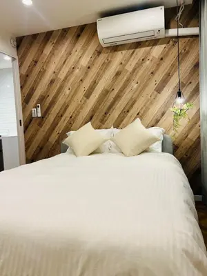 a bedroom with a large white bed and a fan at YFhouse\u6c60\u888bikebukuro-Direct to Ginza, Tokyo Dome, and the Harry Potter Studio Tour Tokyo in Tokyo