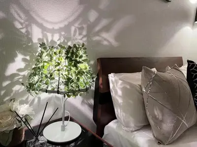 a bedroom with a bed with a plant hanging from the wall at YFhouse\u6c60\u888bikebukuro-Direct to Ginza, Tokyo Dome, and the Harry Potter Studio Tour Tokyo in Tokyo