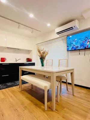 a dining room with a table and chairs and a kitchen at YFhouse\u6c60\u888bikebukuro-Direct to Ginza, Tokyo Dome, and the Harry Potter Studio Tour Tokyo in Tokyo