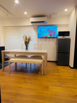 a dining room with a table and a tv at YFhouse\u6c60\u888bikebukuro-Direct to Ginza, Tokyo Dome, and the Harry Potter Studio Tour Tokyo in Tokyo