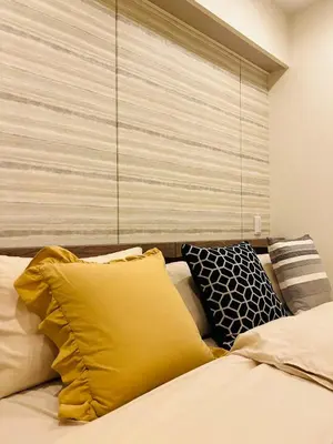 a bed with yellow pillows in a bedroom at YFhouse\u6c60\u888bikebukuro-Direct to Ginza, Tokyo Dome, and the Harry Potter Studio Tour Tokyo in Tokyo