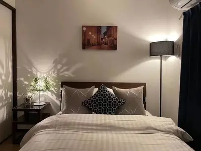a bedroom with a bed with two lamps and a bed sidx sidx sidx at YFhouse\u6c60\u888bikebukuro-Direct to Ginza, Tokyo Dome, and the Harry Potter Studio Tour Tokyo in Tokyo