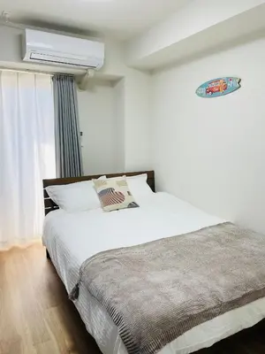a bedroom with a large white bed and a window at T-Hotel \u6d45\u8349 in Tokyo