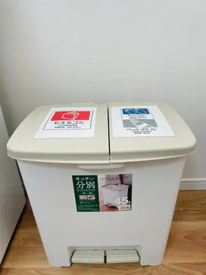 a white toilet with two signs on top of it at T-Hotel \u6d45\u8349 in Tokyo