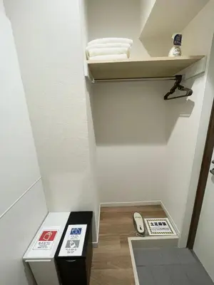 a small room with a stairway with a shelf and a scale at T-Hotel \u6d45\u8349 in Tokyo