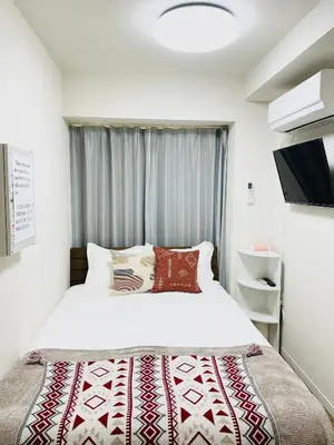a bedroom with a bed and a window at T-Hotel \u6d45\u8349 in Tokyo