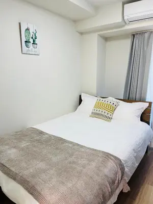 a bedroom with a white bed and a window at T-Hotel \u6d45\u8349 in Tokyo