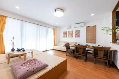 a living room with a couch and a table at Joint Court Kameido in Tokyo