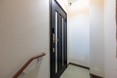 an open door in a hallway with a staircase at Joint Court Kameido in Tokyo