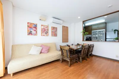 a living room with a couch and a table at Joint Court Kameido in Tokyo