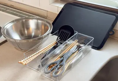 a plastic container filled with utensils on a kitchen counter at \u30ab\u30e1\u30ea\u30a2\u30d3\u30eb in Tokyo