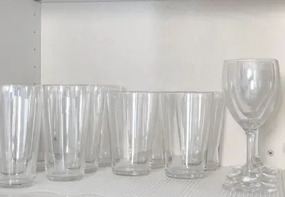 a row of empty glasses sitting on a table at \u30ab\u30e1\u30ea\u30a2\u30d3\u30eb in Tokyo