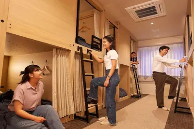a group of people in a room with bunk beds at GRAND HOSTEL LDK Tokyo Nishikasai -GRAND OPENING In May 2025- in Tokyo