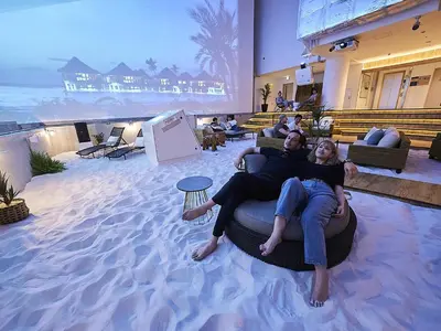 two people laying on a circular bed in the sand at GRAND HOSTEL LDK Tokyo Nishikasai -GRAND OPENING In May 2025- in Tokyo