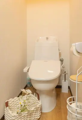a bathroom with a toilet and a basket of flowers at Shinjuku 2 stops new mansion free WiFi nakano area in Tokyo
