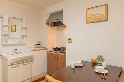 a small kitchen with a table and a sink at Shinjuku 2 stops new mansion free WiFi nakano area in Tokyo
